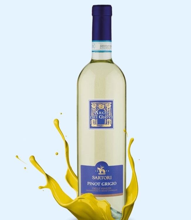 A bottle of Pinot Grigio delle Venezie DOC Arco dei Giovi by Sartori 2019 stands in centre frame inside a splash of yellow wine.